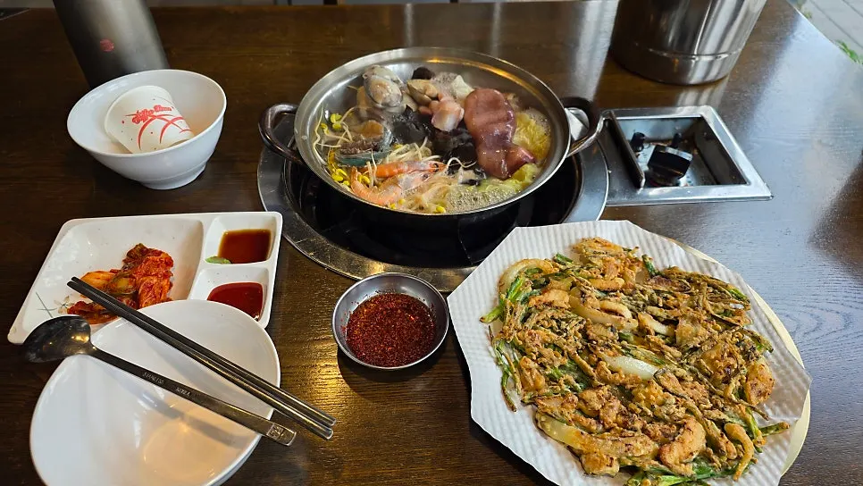 Seafood kalguksu bubbling away on the tableside burner