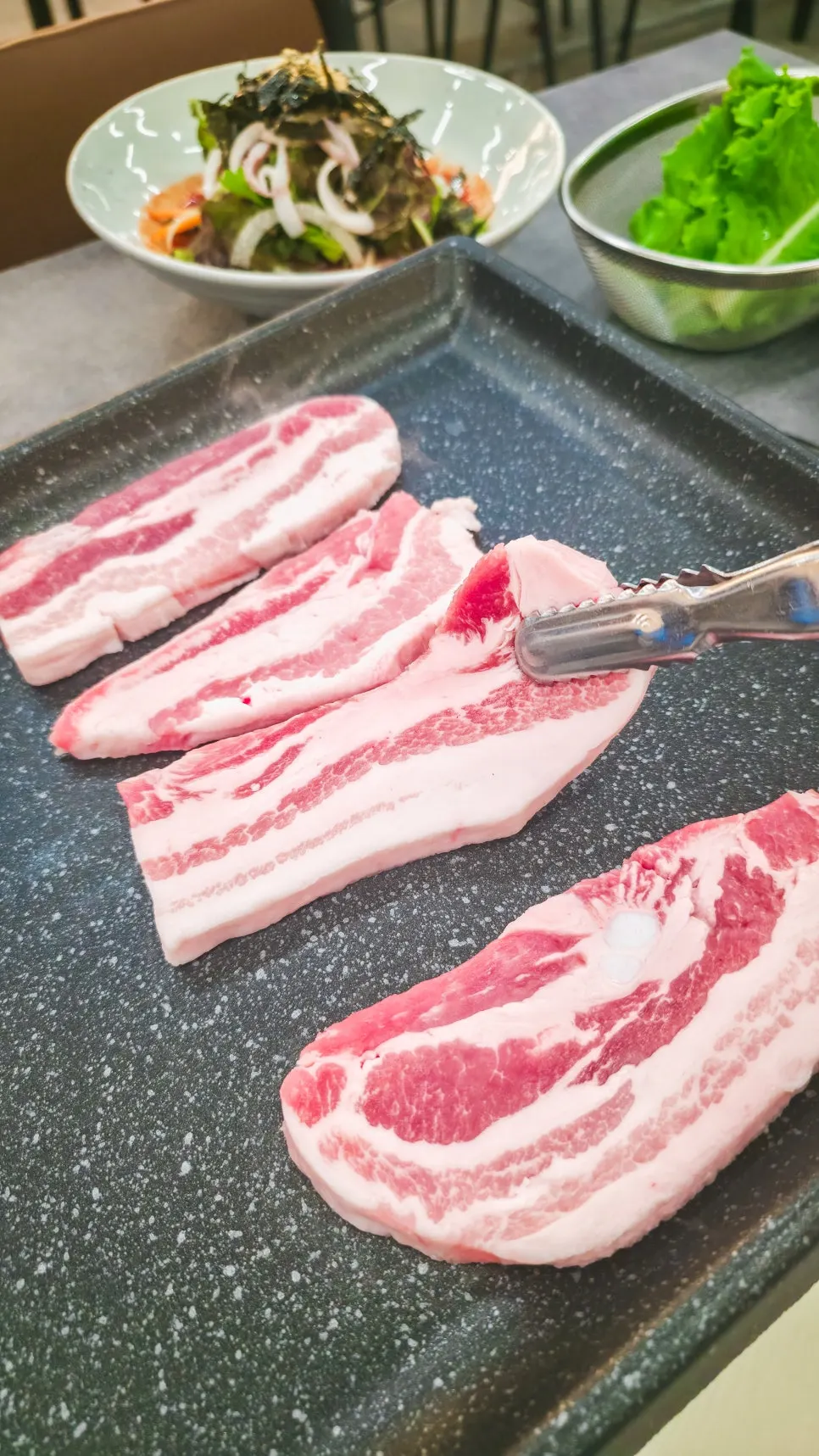 Plate of vivid red raw pork belly