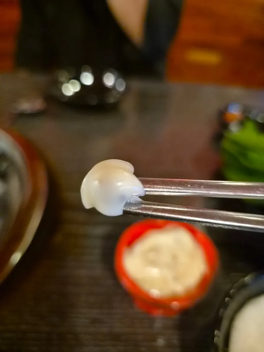 A bite of octopus soaked in spicy sauce