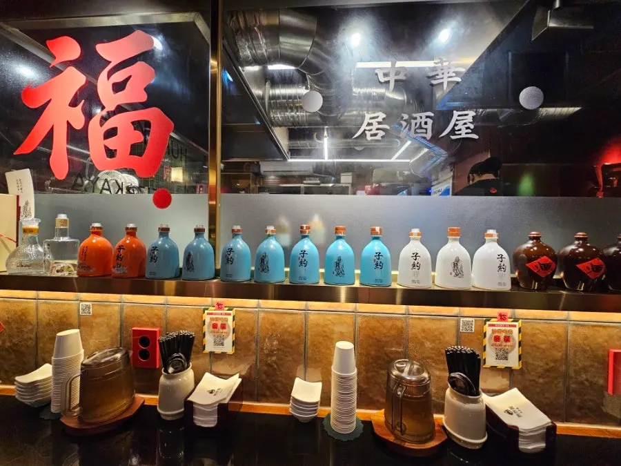 Wall shelf neatly arranged with paper cups and water bottles