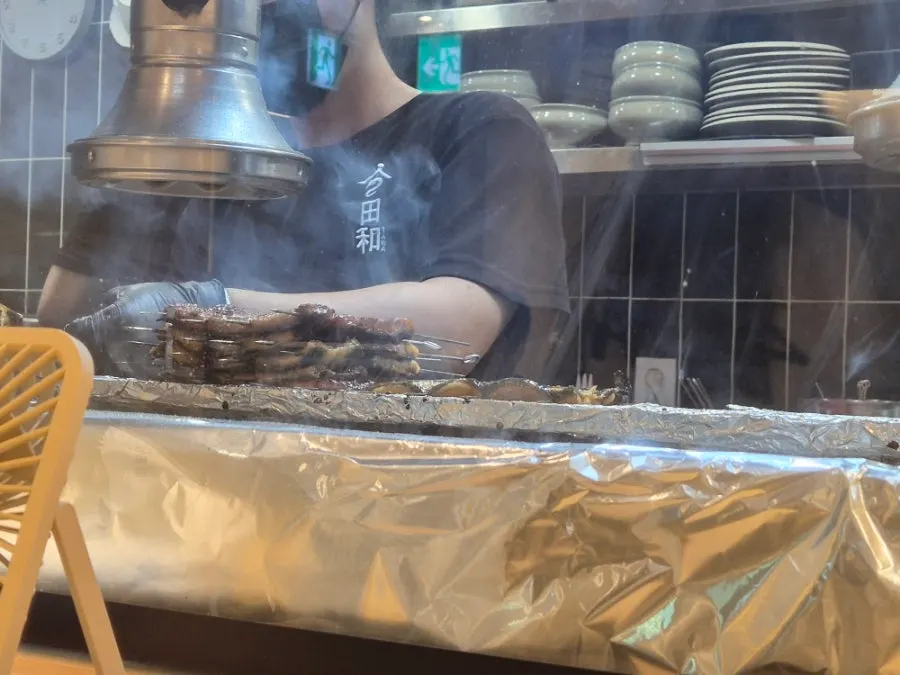 Eel grilling in front of the bar table