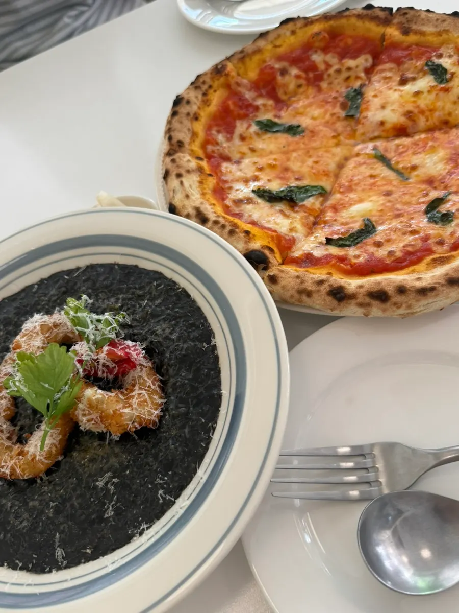 Margherita pizza and squid ink risotto on the table at Classicdang