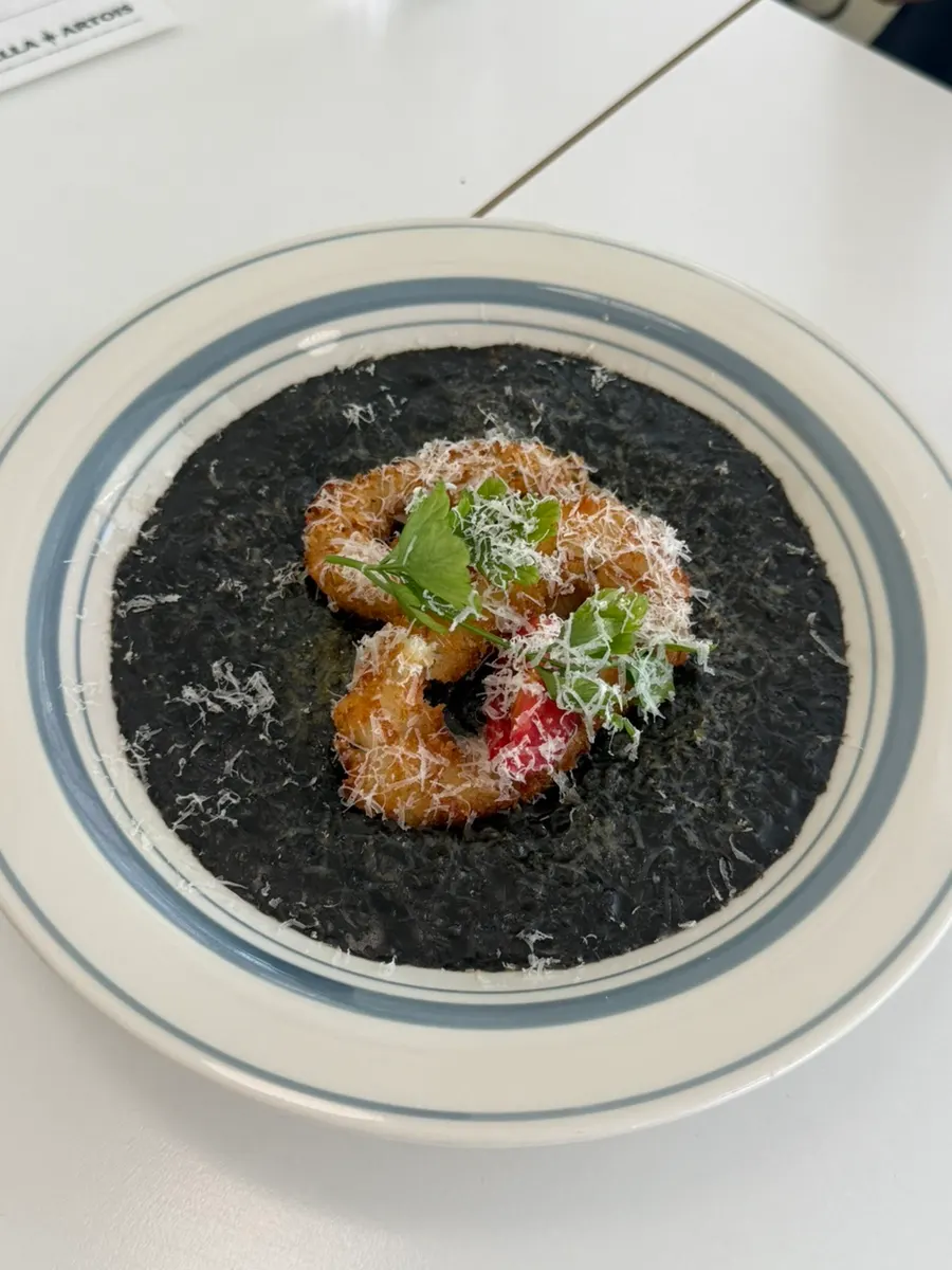 Squid ink risotto topped with fried squid