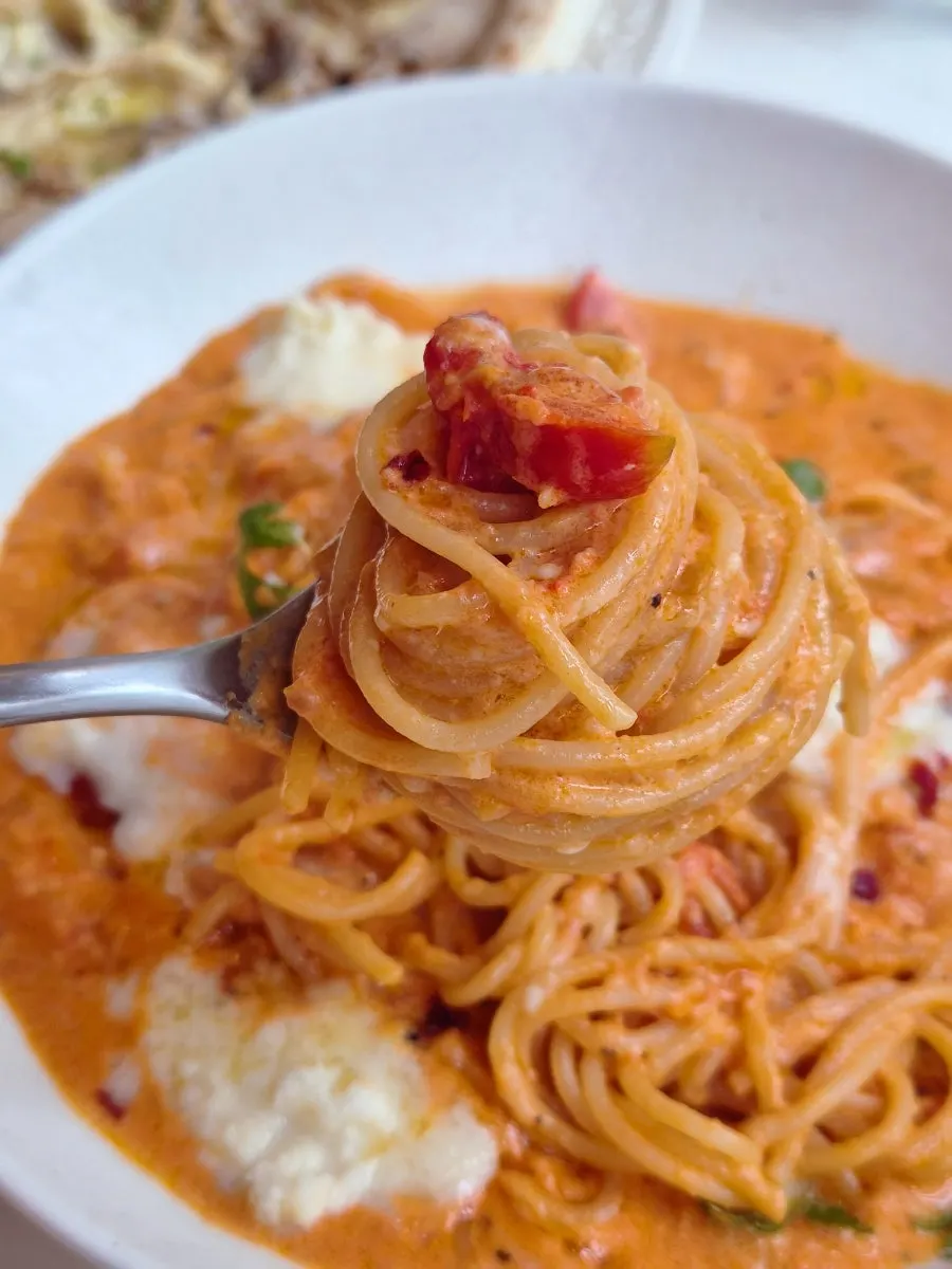 Dipping pizza crust into the rosé sauce
