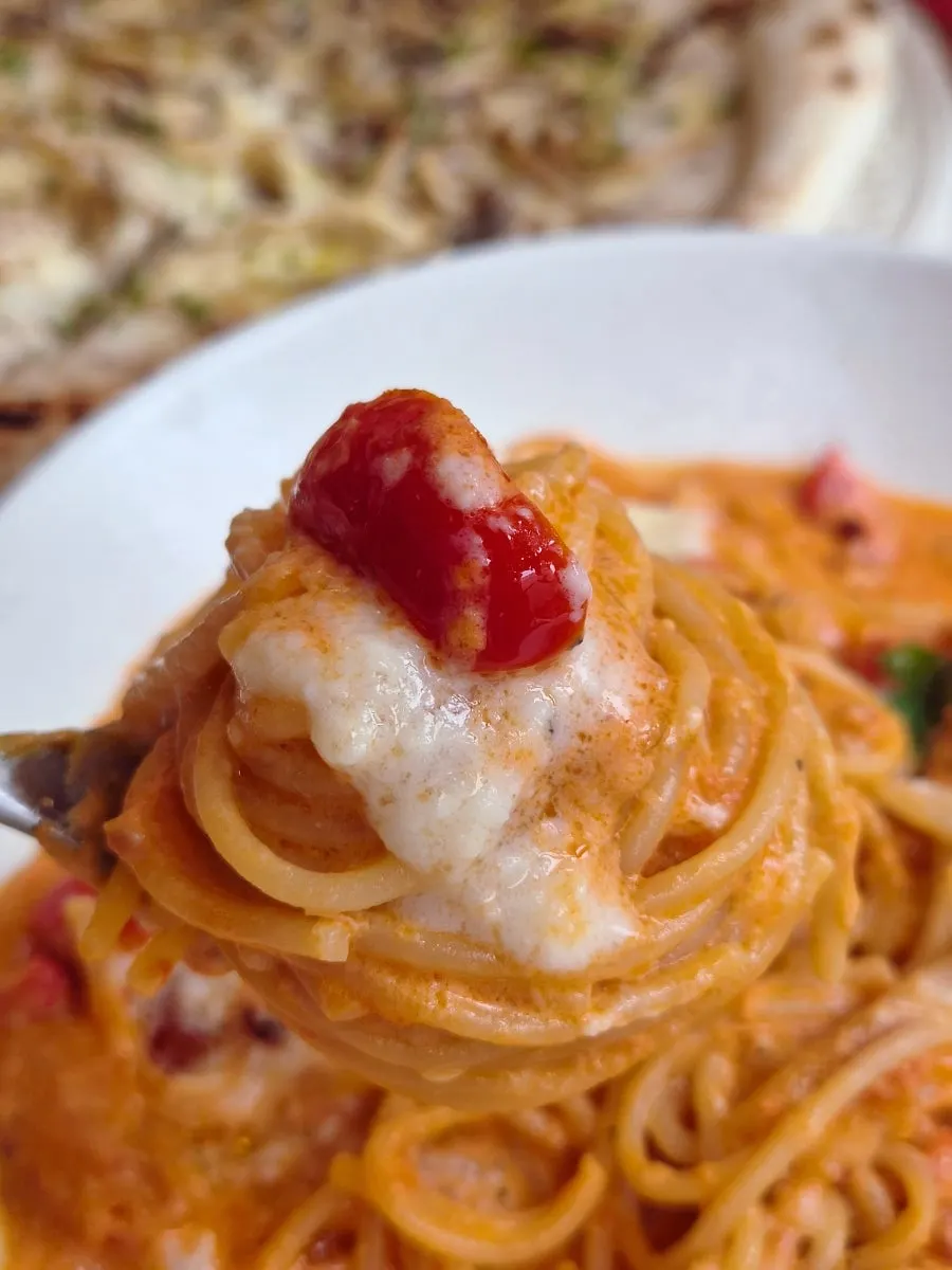 Pizza and pasta placed together on the table