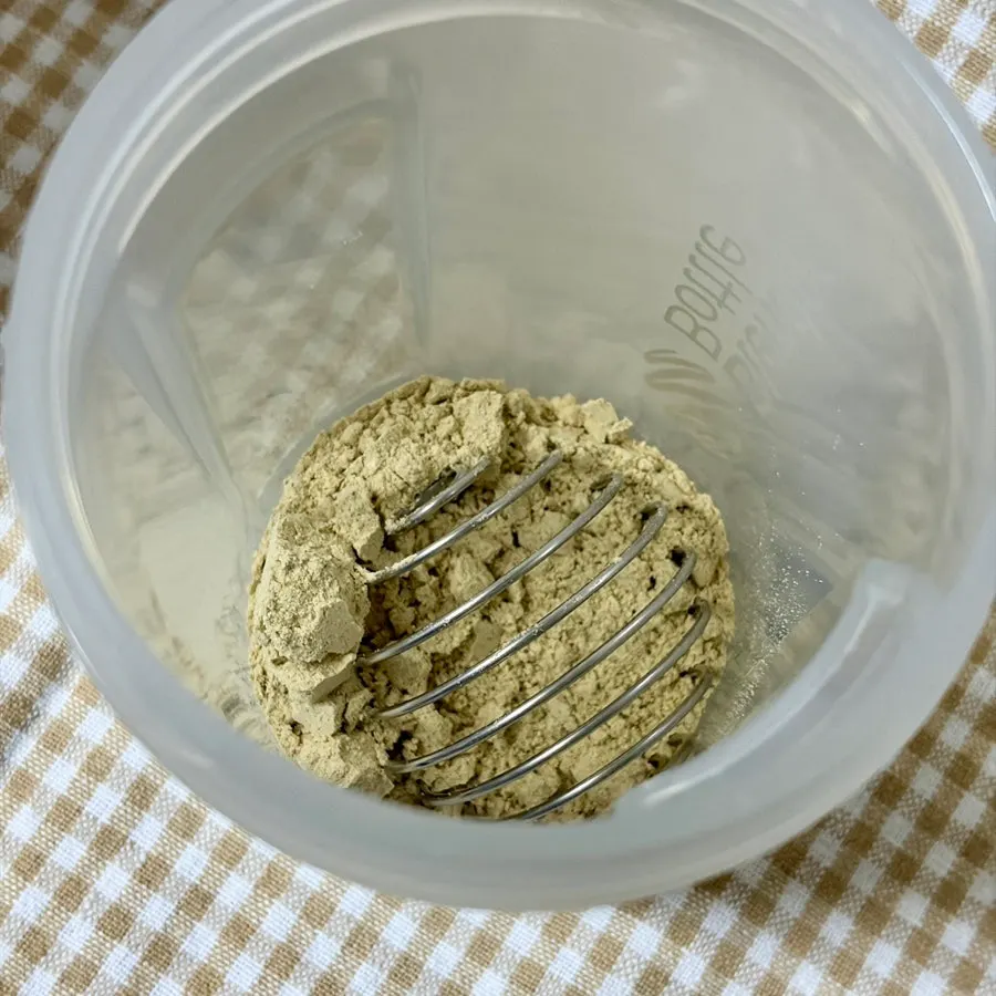 Cleanit Black Bean powder poured into a shake bottle