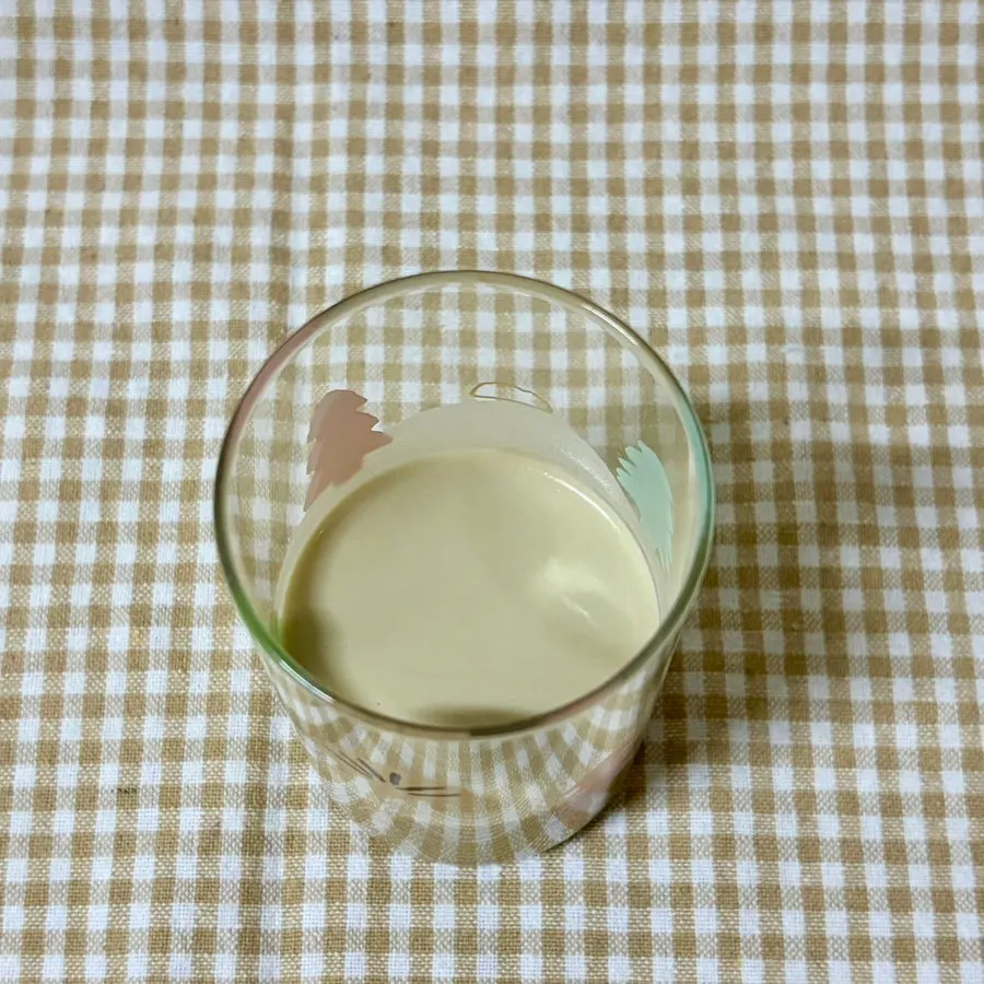 A glass of black bean shake the color of misugaru