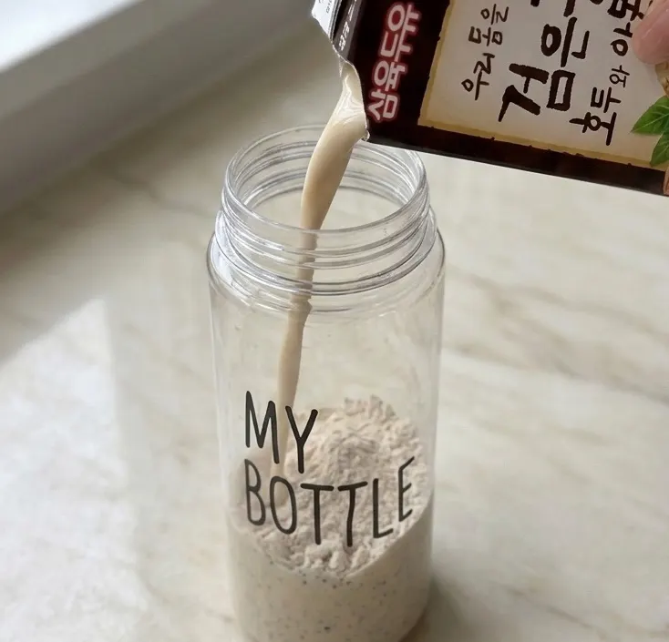 A cup of Cleanit Black Bean mixed with soy milk