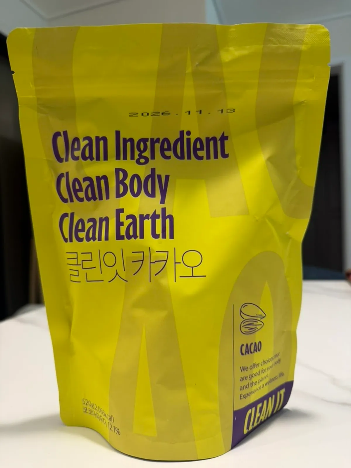 Holding a container of Cleanit Cacao protein shake