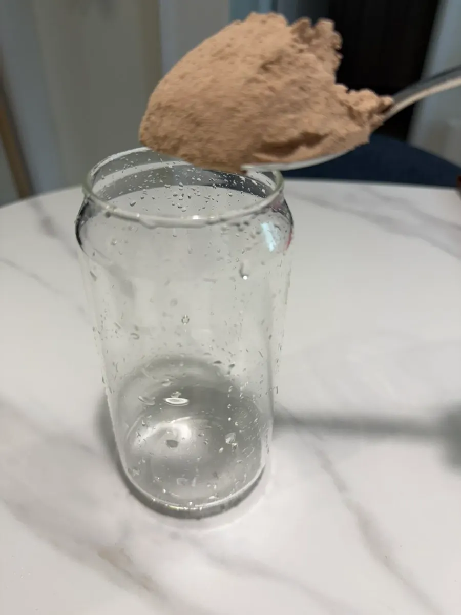 A finished glass of cacao protein drink