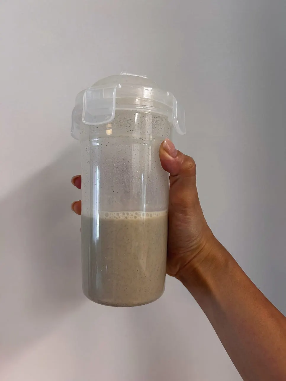 Adding powder and water into a shaker bottle