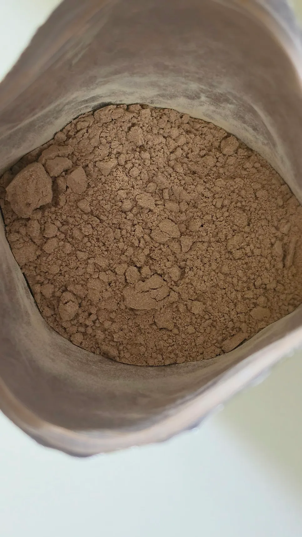 Opened cacao-flavored protein powder