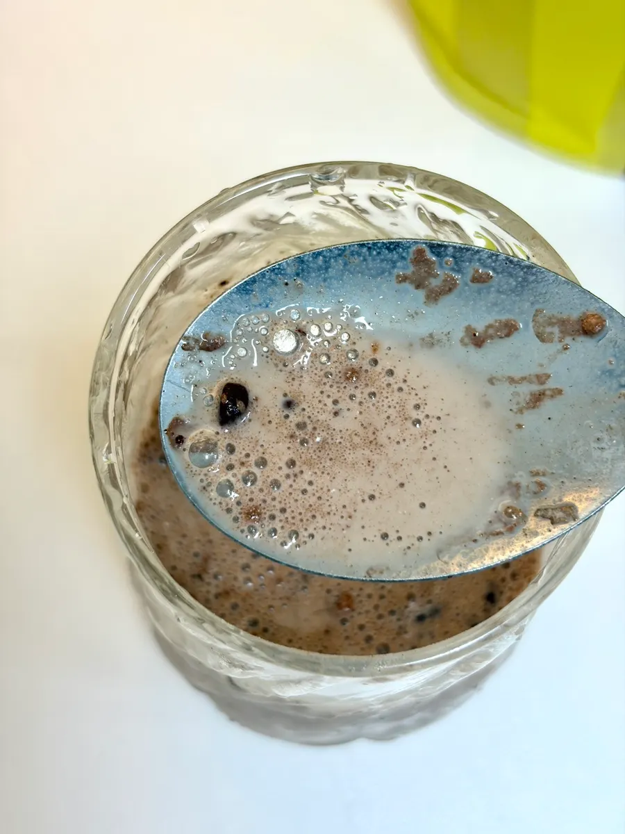 Glass of cacao protein shake stirred and mixed