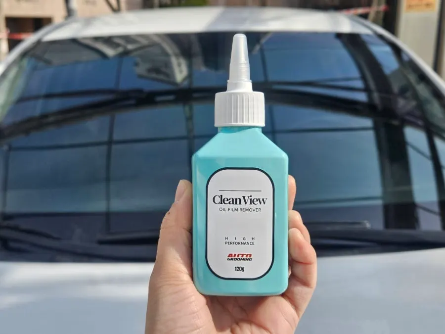 Car windshield with oil film making visibility frustrating