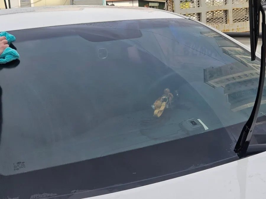 Rubbing car glass with the included towel