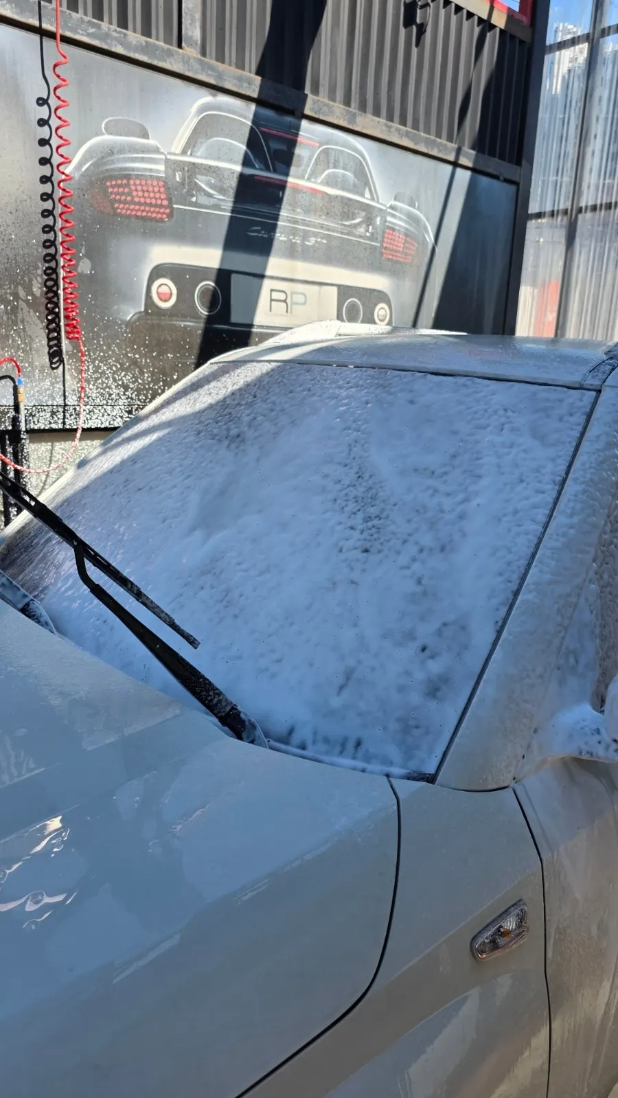 Preparing to clean car glass and use AutoGrooming Oil Film Remover