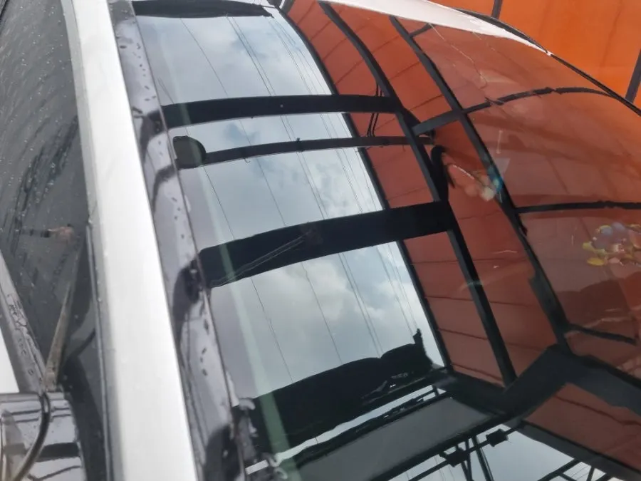 Rinsing oil-film remover from a car windshield with high-pressure water