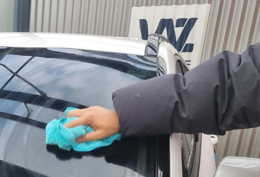 Car windshield comparison of an area treated with oil-film remover