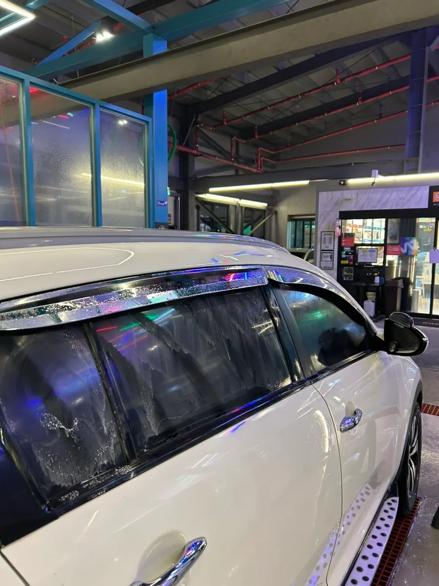Rubbing the car glass surface with a towel