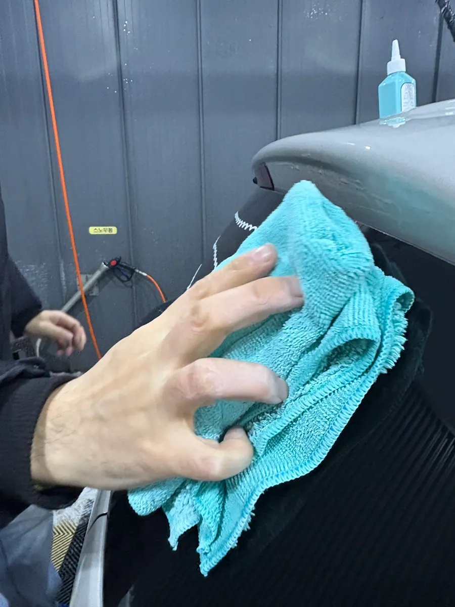 Rear car window with oily film removed after the windshield