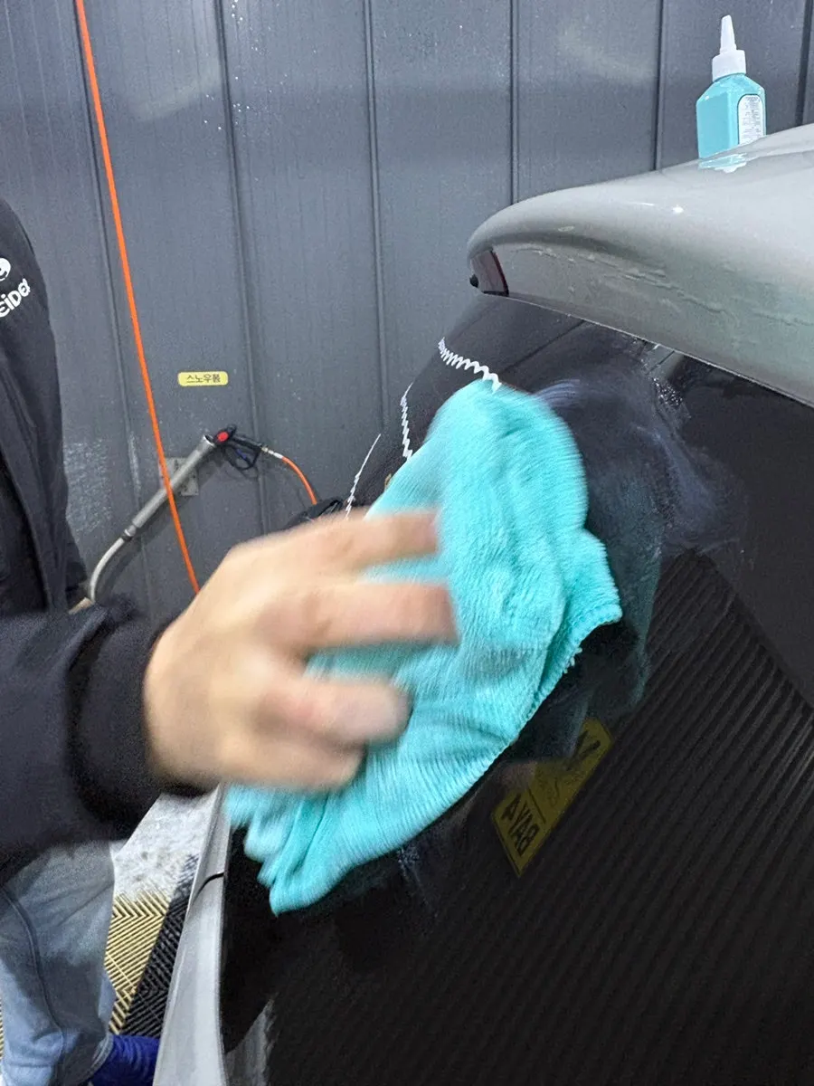 Car window rinsed with water and finished with a dry towel