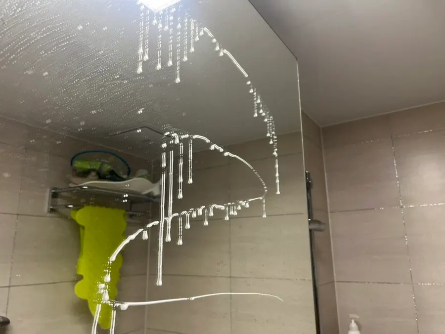 Applying oil-film remover to wet glass