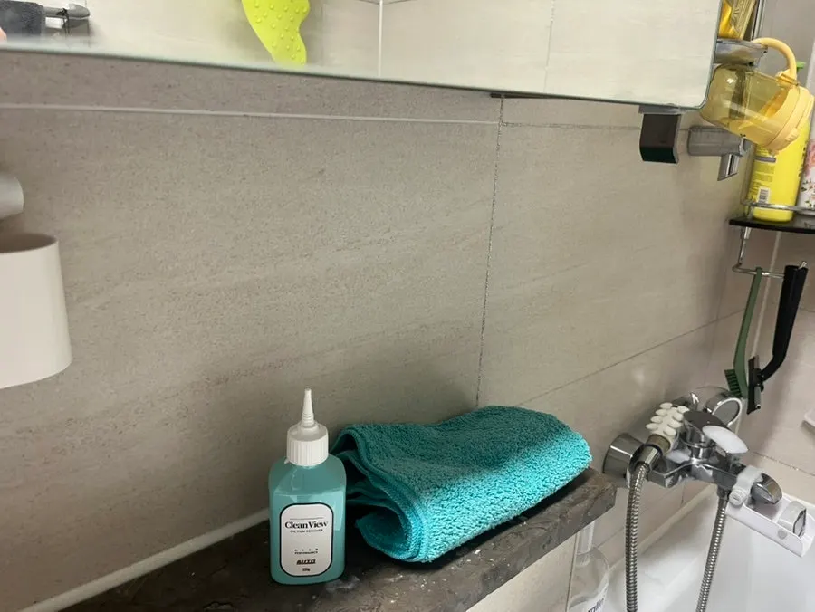 Spreading and wiping oil-film remover with the dedicated towel