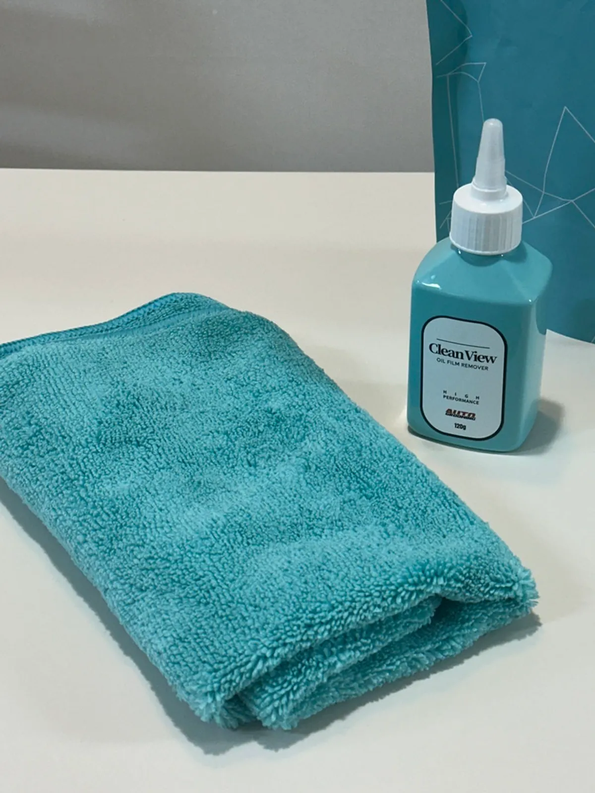 Cleaning with Clean View glass film remover using the dedicated towel