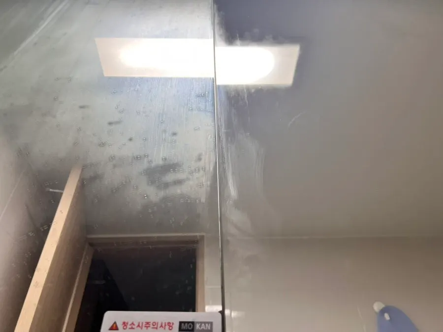 Finishing glass cleaning with a dedicated towel dampened with water
