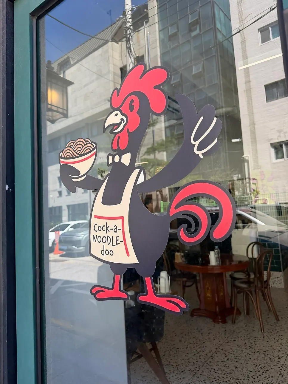 Entrance of Cocker Noodle Two decorated with a chicken figure