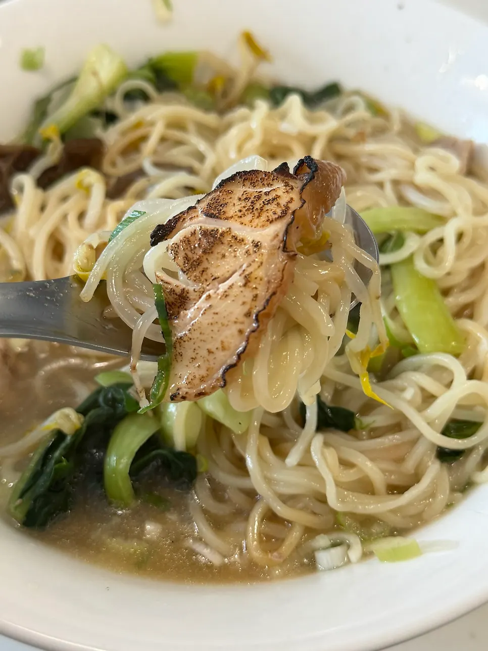 Close-up of long-blanched bok choy on the ramyeon