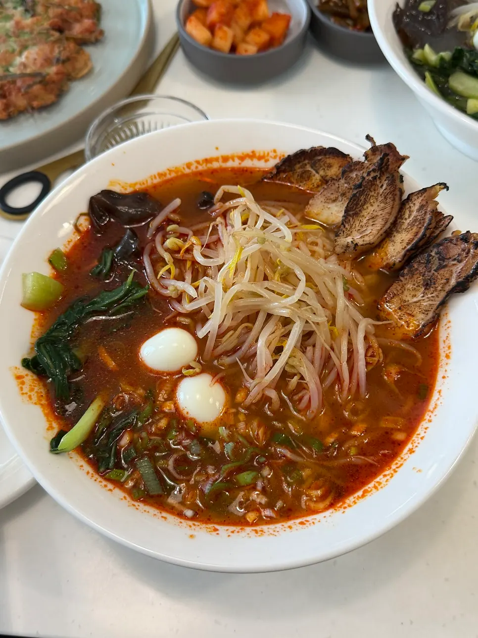 Thin noodles lifted up, coated in broth
