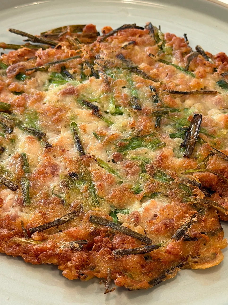 A piece of dakjeon dipped in soy sauce