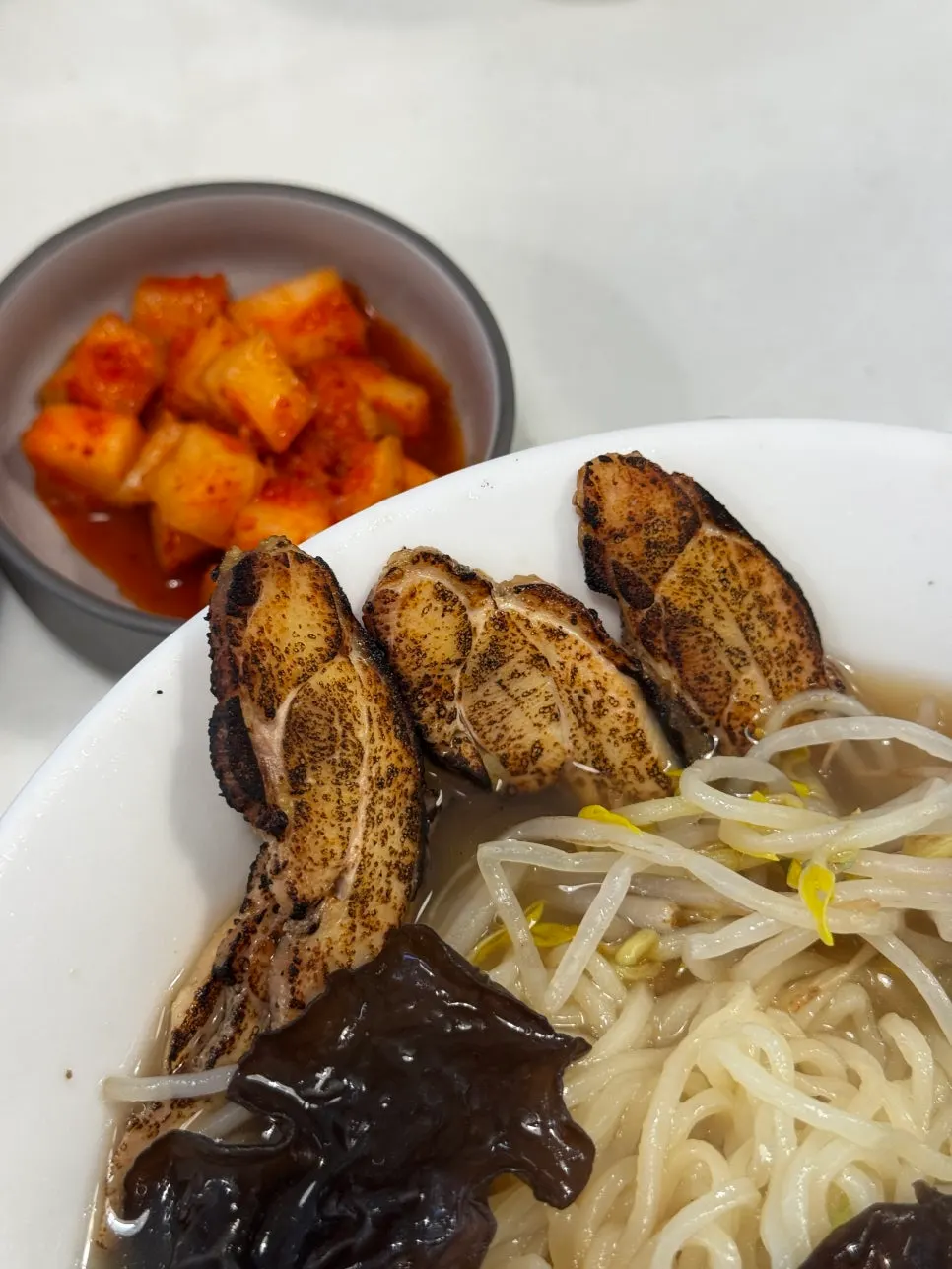 Ramen broth topped with smoked chicken