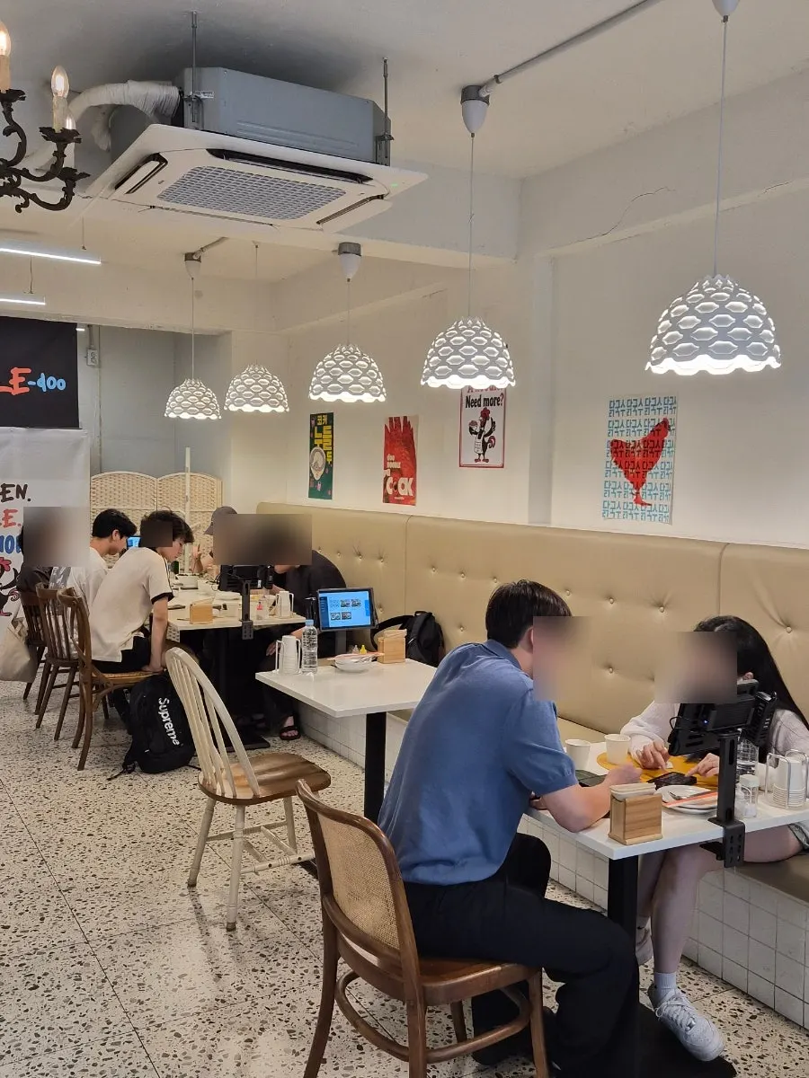 Interior of Cocker Noodle Two, fully booked on a weekend evening