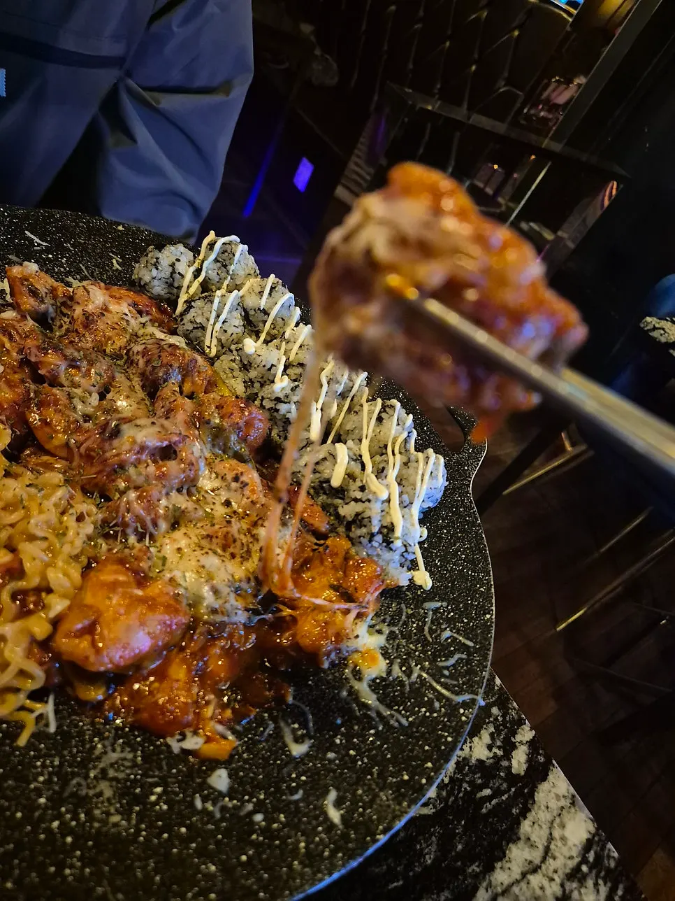 Melted cheese over chicken galbi with tuumba noodles