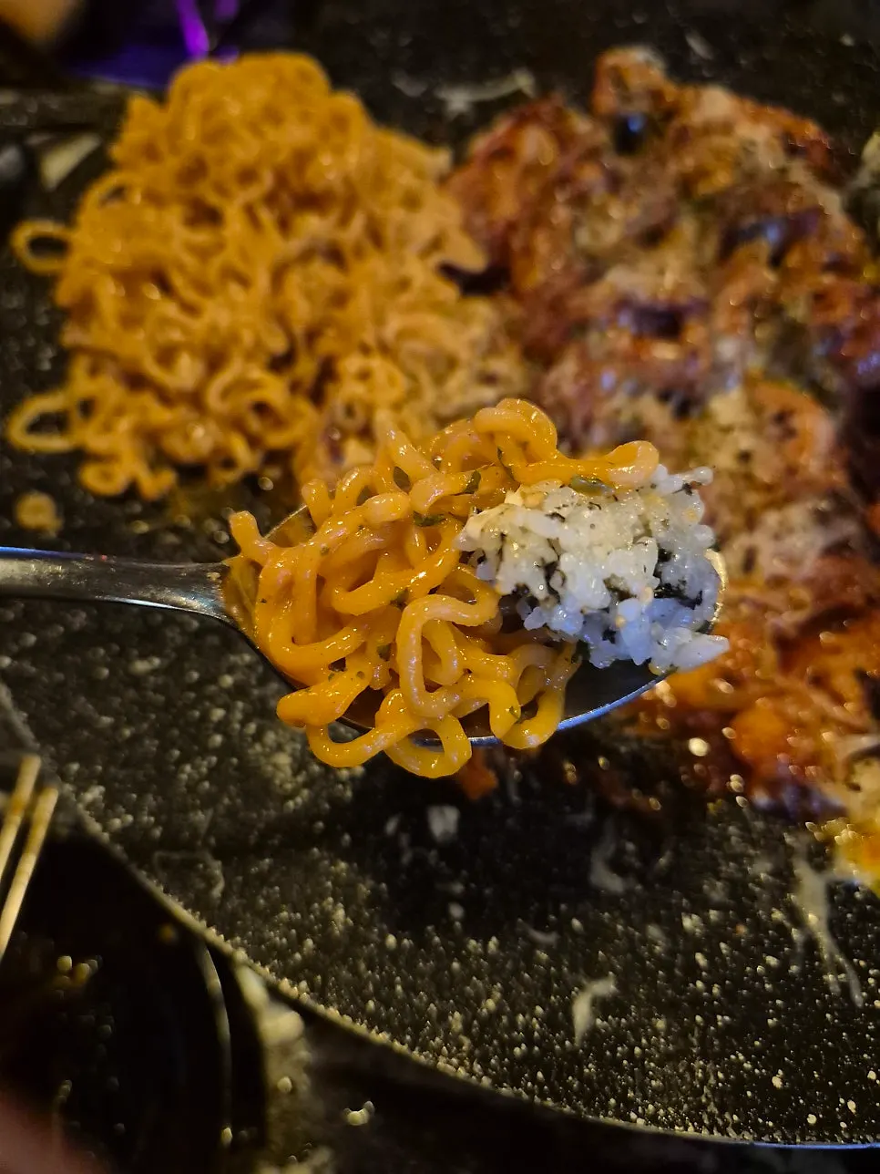 A bite of sweet-and-spicy cheese chicken galbi
