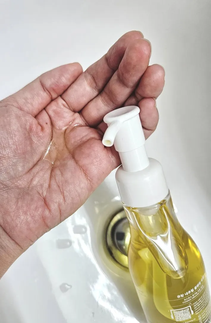 The cleansing oil's texture dispensed onto a hand
