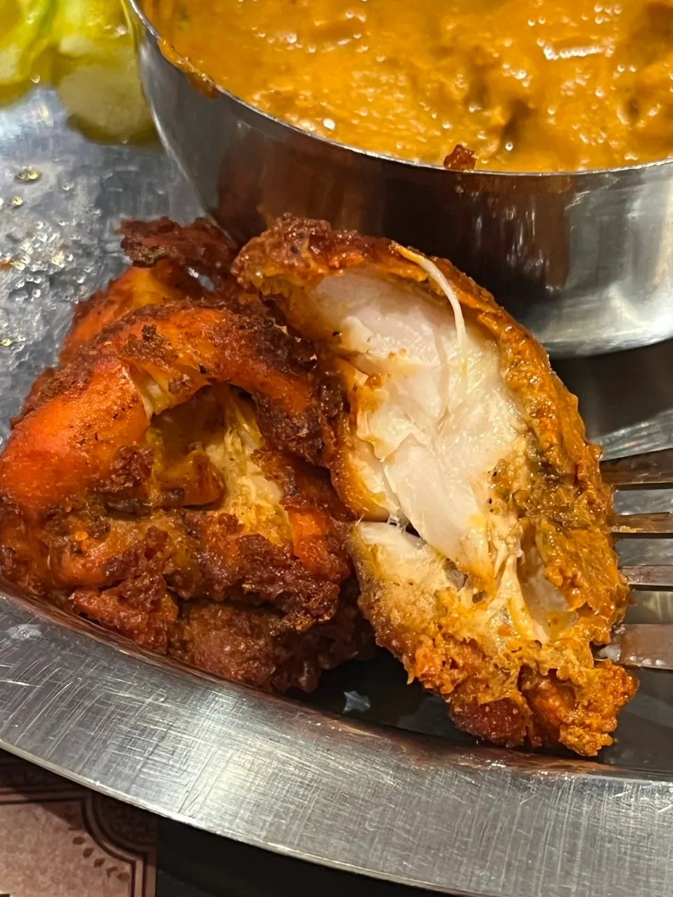 Close-up of smoky-charred chicken tikka