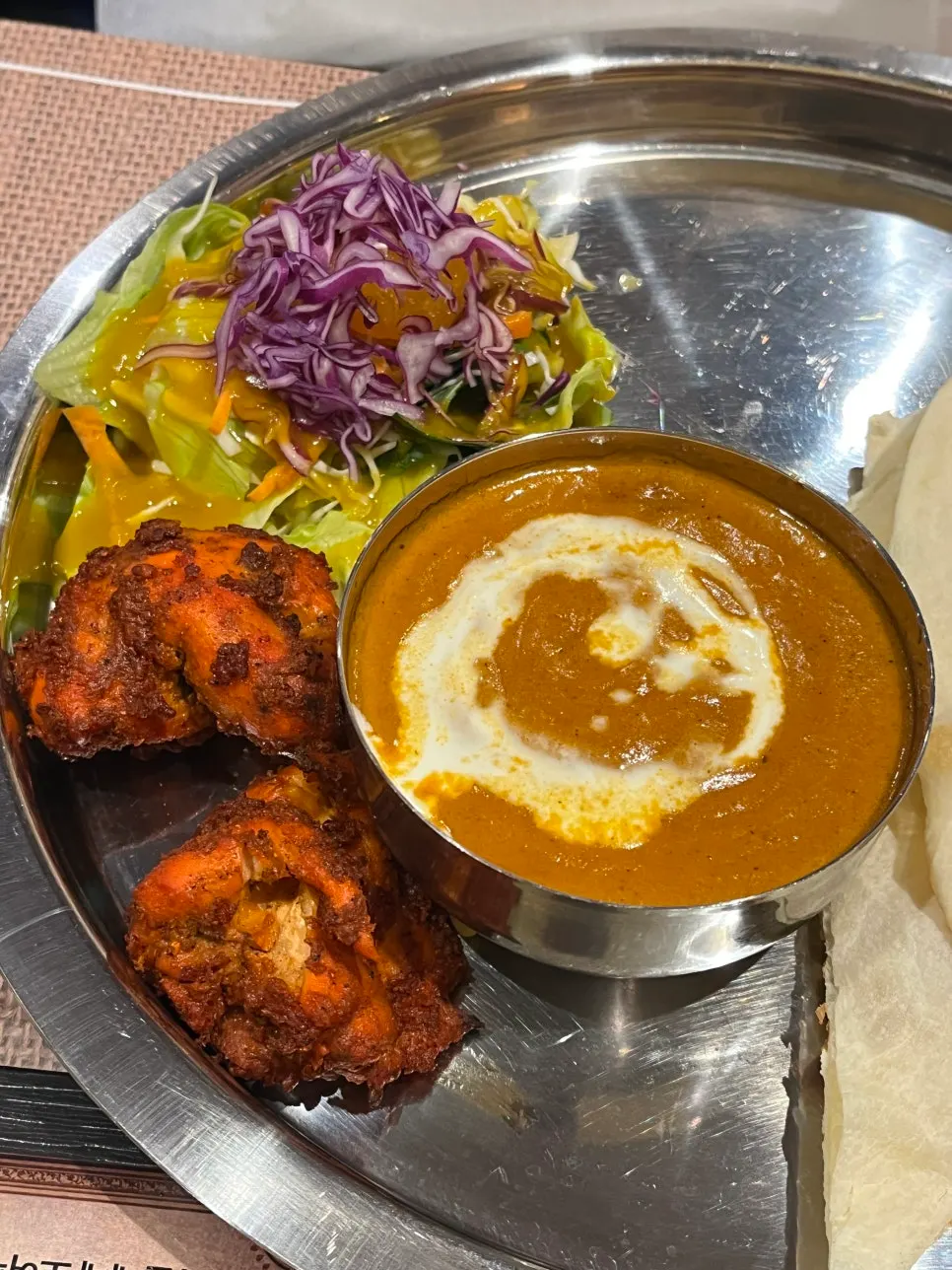 Chicken makhani being dipped with naan