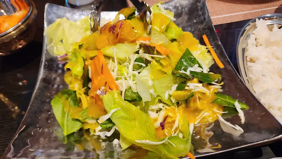 Fresh salad topped with citrus sauce