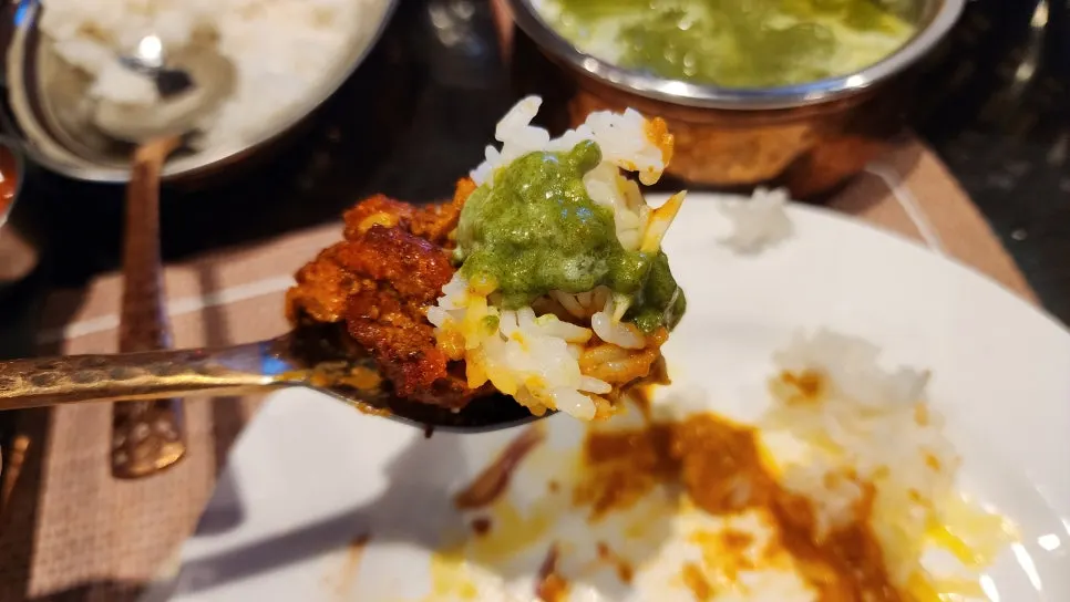 A plate of rice mixed with curry poured over it
