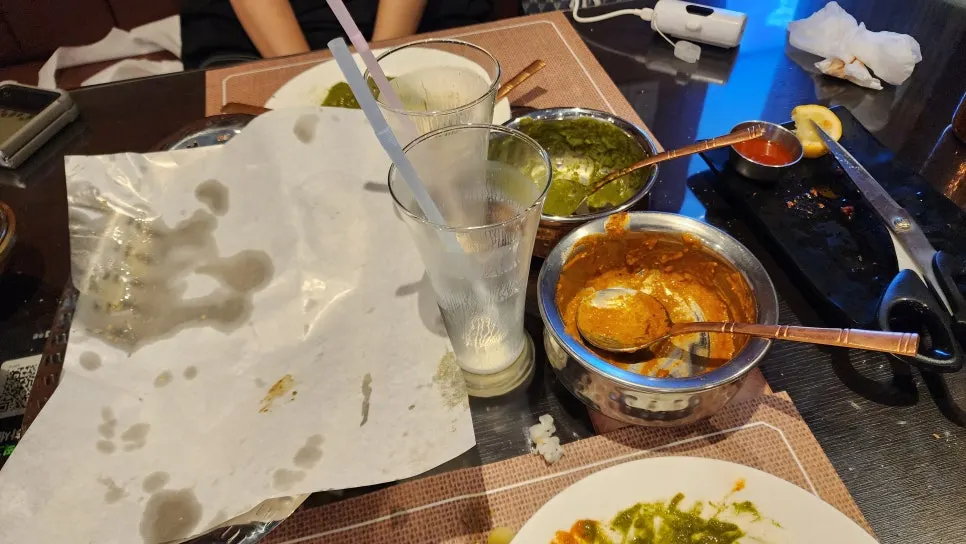 Empty curry plates and bowls after finishing the meal