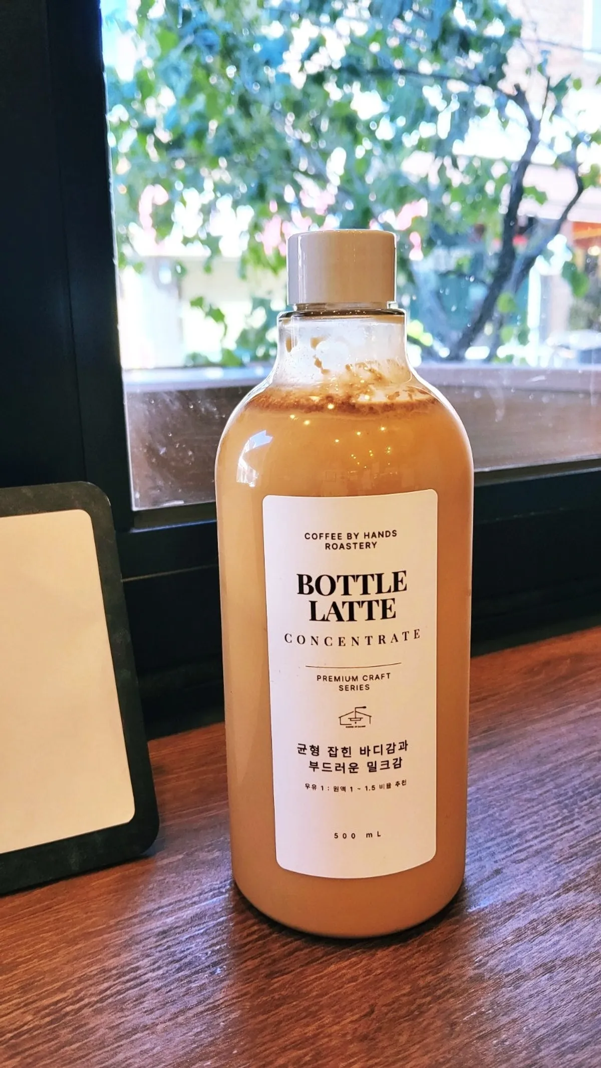 Bottle latte placed at a window seat