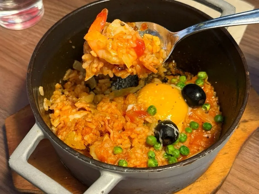노른자를 터뜨려 비빈 빠에야 한 스푼