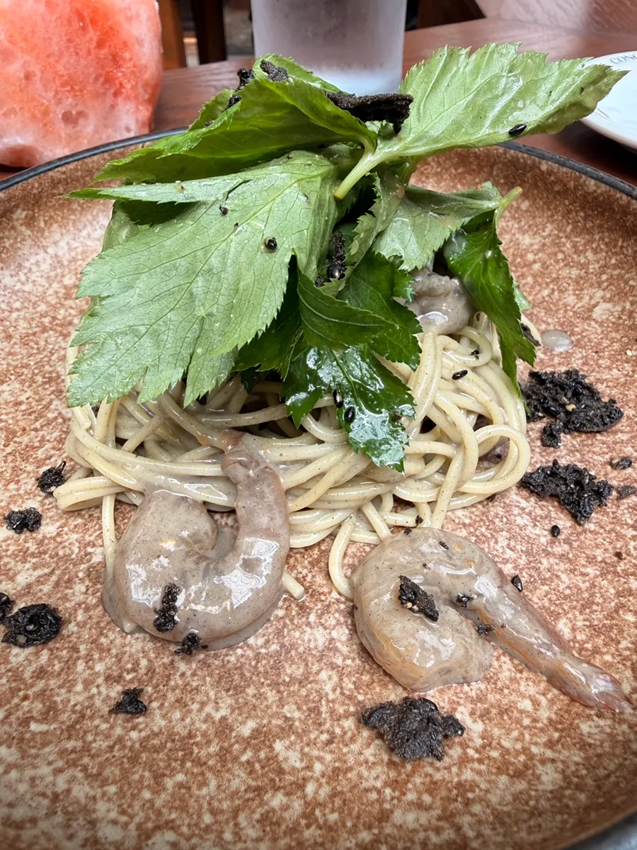 Fork lifting a bite of soy crab pasta