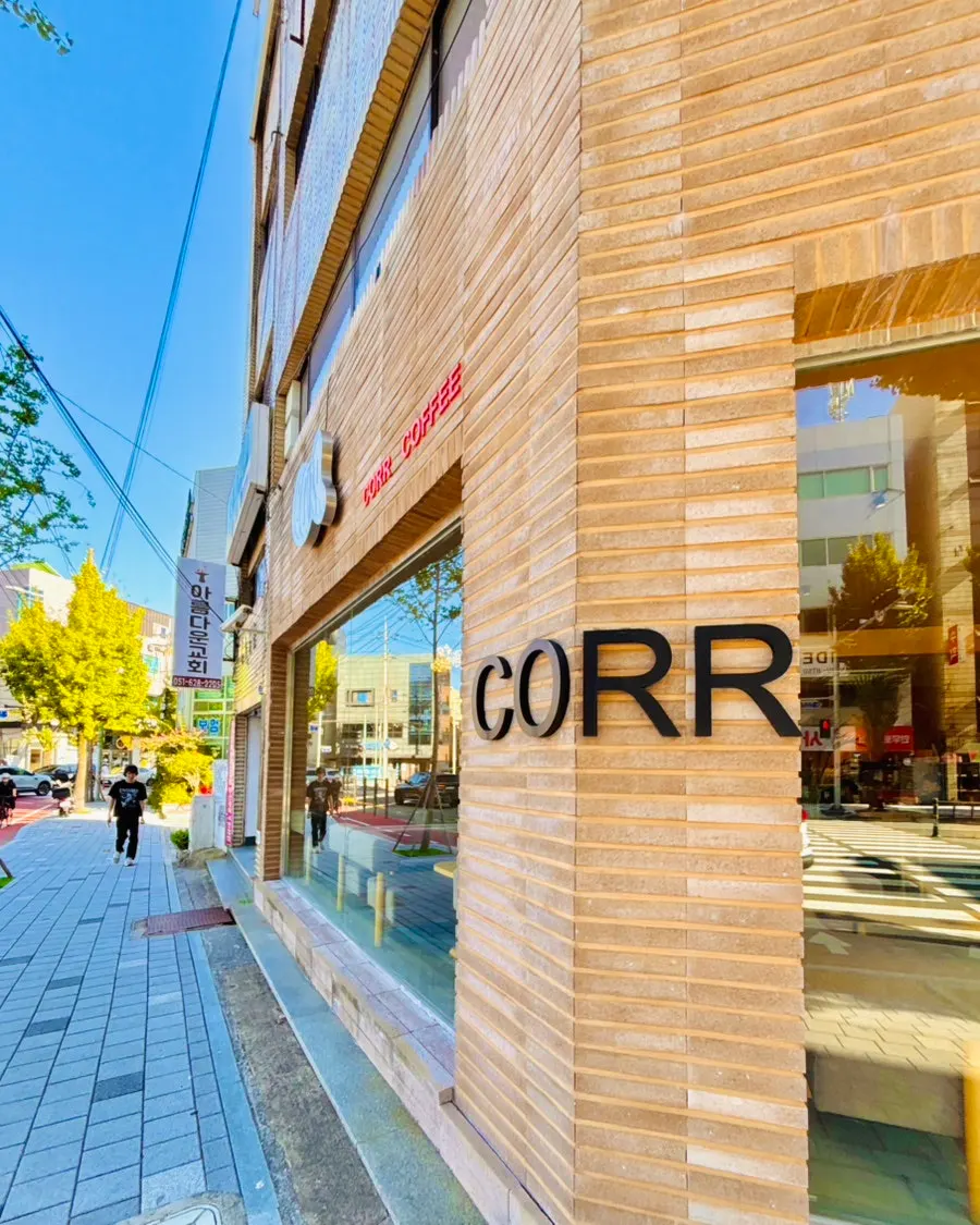 Exterior of CORR on the corner of the first floor of a brick building