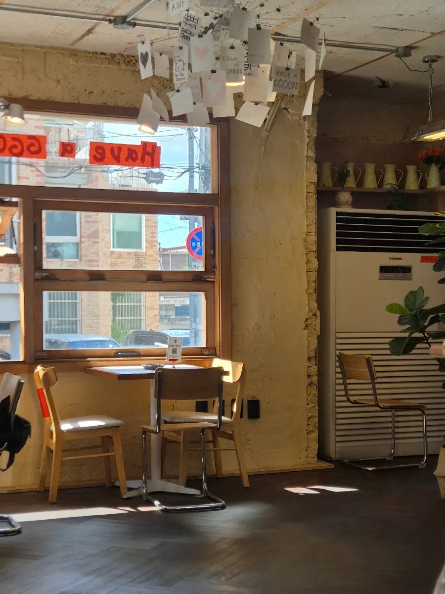 Window seat on the 2nd floor with a view outside through floor-to-ceiling windows