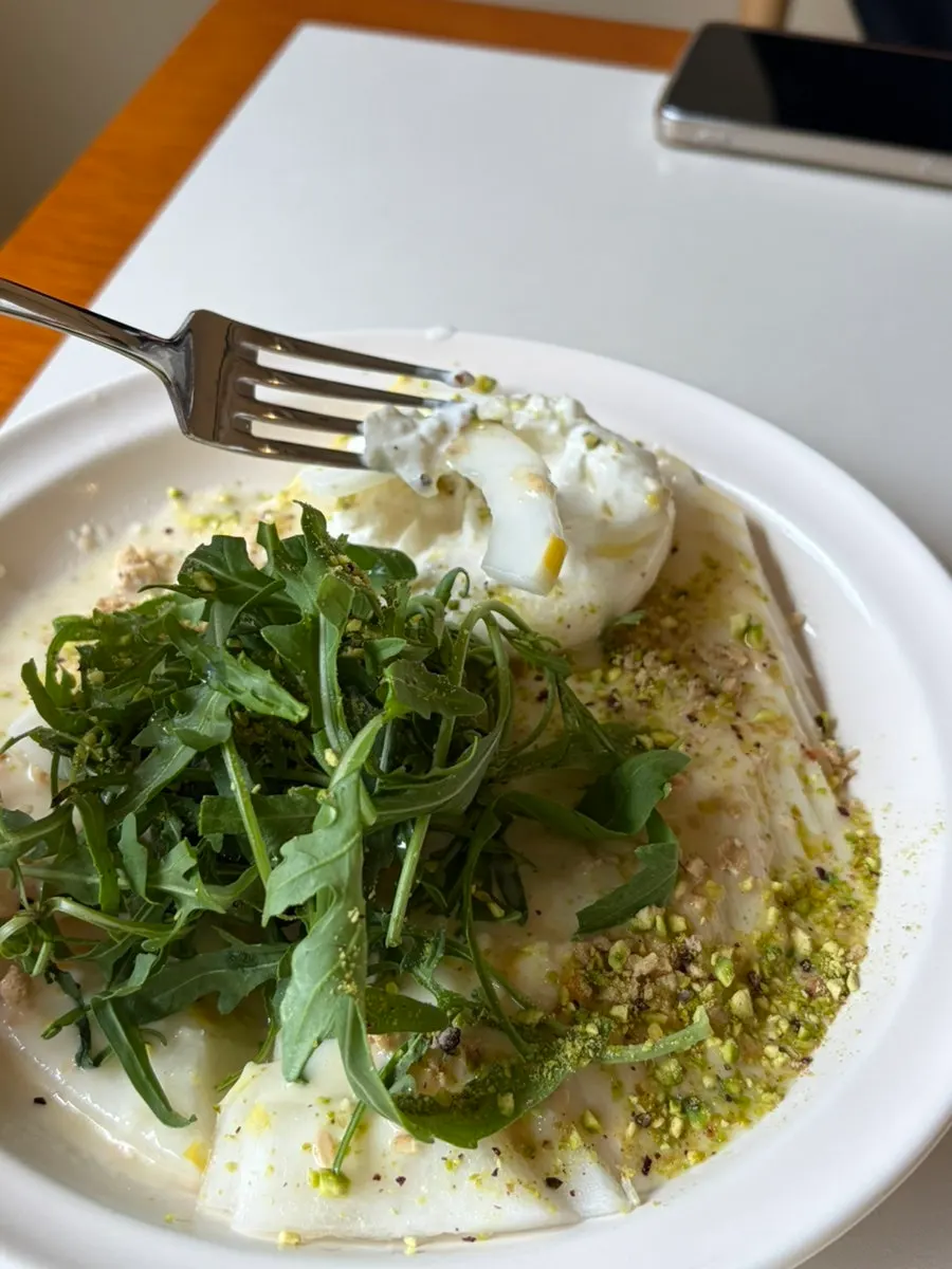 Salad topped with burrata cheese and melon