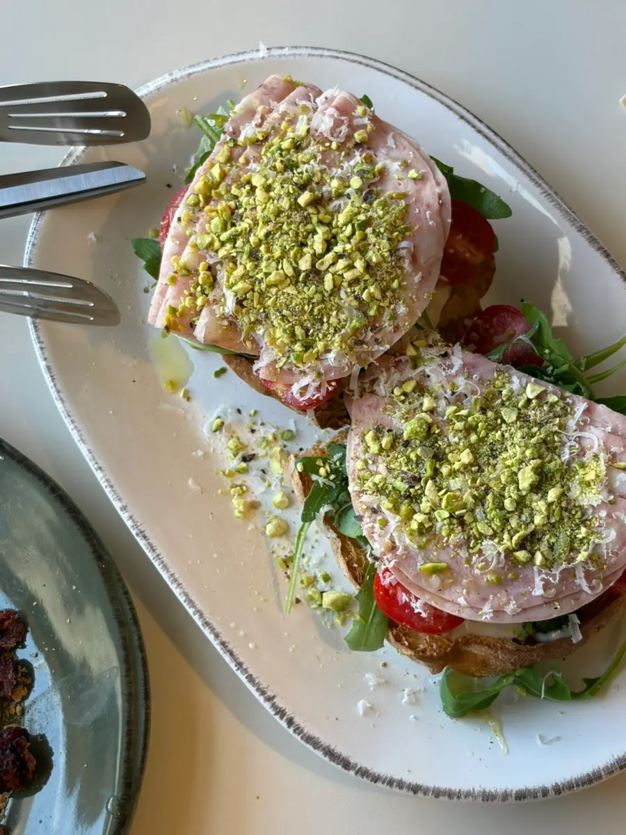 Mortadella arugula open sandwich on ciabatta